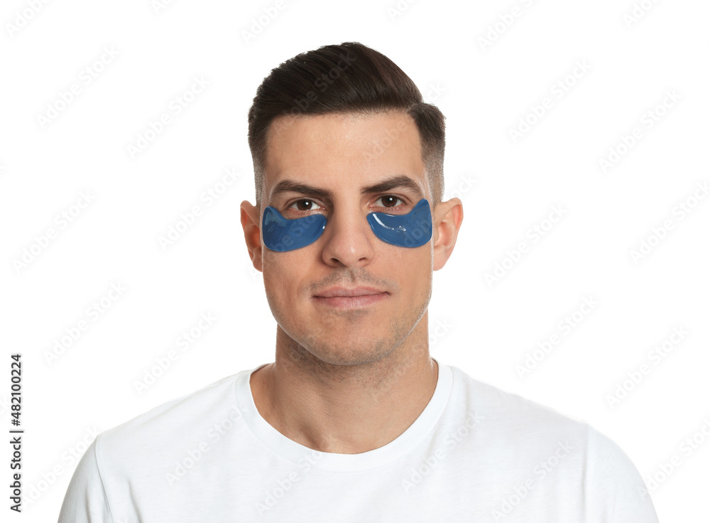 Man with blue under eye patches on white background Man with blue under eye patches on white background