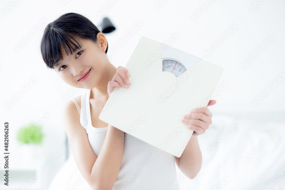 Portrait of beautiful young asian woman holding scales with confident with control and weightloss, girl dieting for result of weight loss with satisfied, one person, healthy and lifestyles concepts. Portrait of beautiful young asian woman holding scales with confident with control and weightloss, girl dieting for result of weight loss with satisfied, one person, healthy and lifestyles concepts.