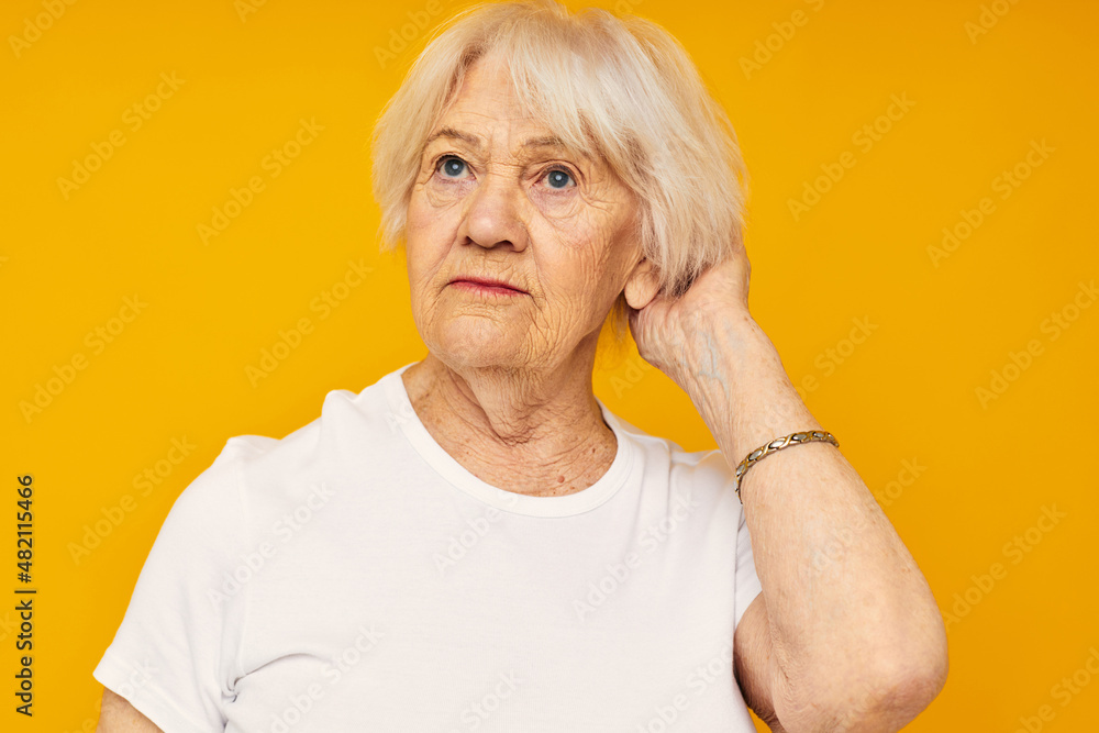 smiling elderly woman in white t-shirt posing fun close-up emotions smiling elderly woman in white t-shirt posing fun close-up emotions