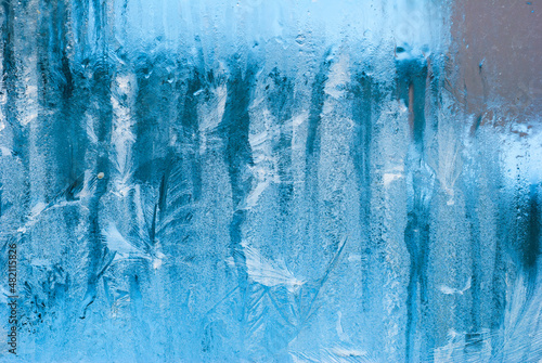 frost work winter background on window glass