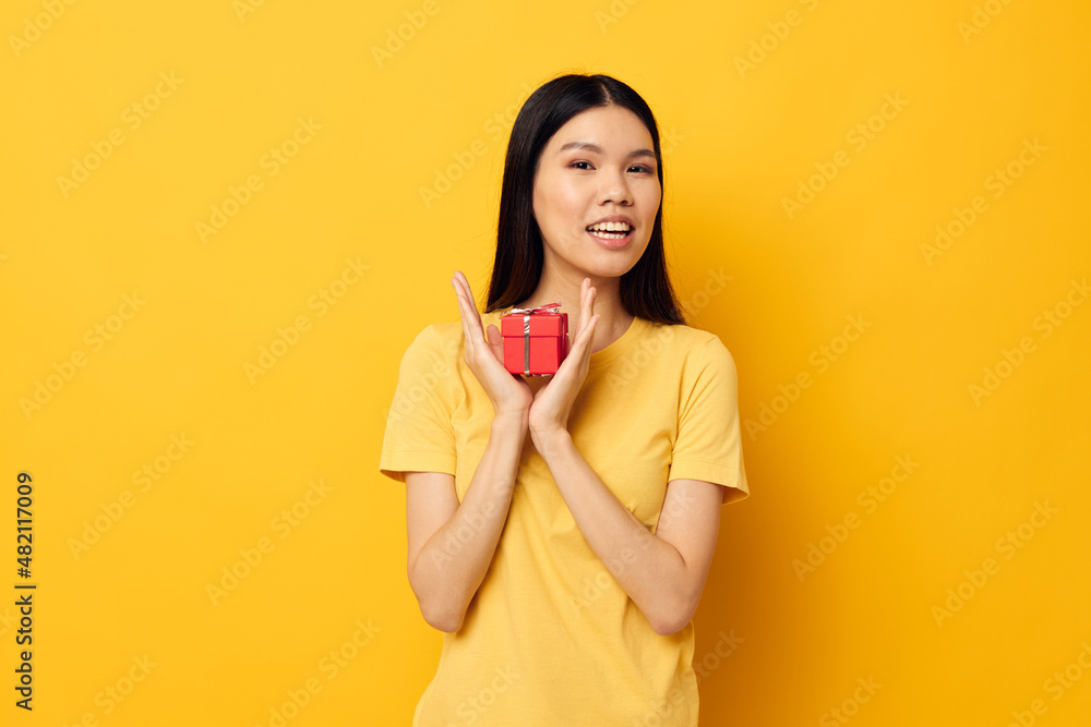 pretty brunette Little red gift box fun yellow background unaltered pretty brunette Little red gift box fun yellow background unaltered