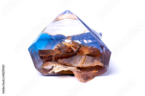Dried pieces of fish in a package isolated on a white background