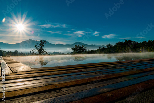 Private resort pool with mist over water in the morning