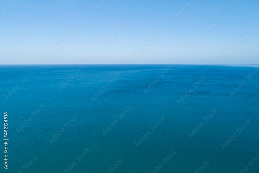 Aerial view of a blue sea surface water texture background and sun reflections Aerial flying drone view Waves water surface texture on sunny tropical ocean in Phuket island Thailand