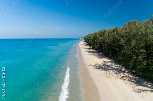 Fototapeta Naklejka Na Ścianę i Meble -  Aerial view Drone camera of Tropical sea with Row of pine trees near the beach in Thailand Beautiful sea and sky Travel and tour concept