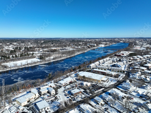 aerial view of river across city with floating ice in winter © nd700