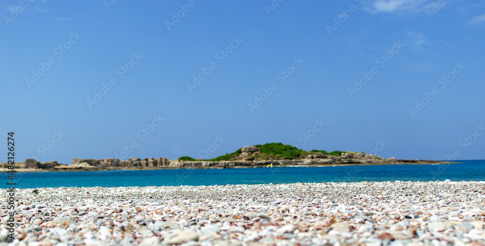the sea shore with stones and the blue sky. the sea shore with stones and the blue sky.