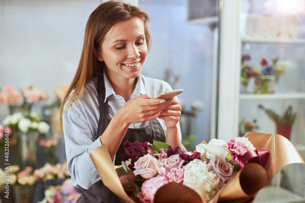 Busy florist photographing freshly made bouquet for social media Busy florist photographing freshly made bouquet for social media