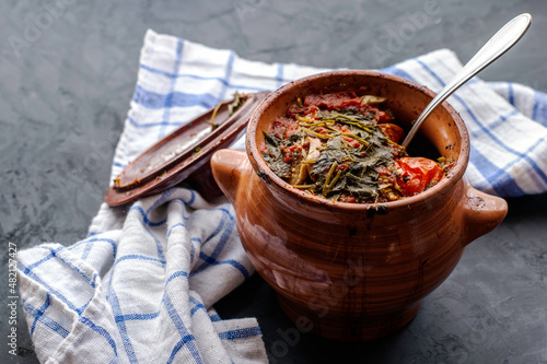 a pot of chanakhi and a towel on a dark background photo