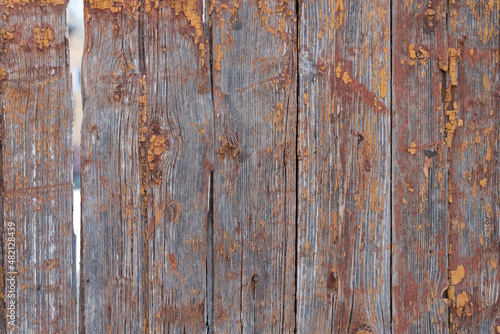 old boards from fences and gates are covered with dirt and old paint © arthurkochiev