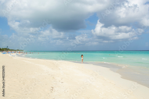 Wonderful white sandy beach  tourists and Caribbean sea many dark clouds background  Varadero  Cuba