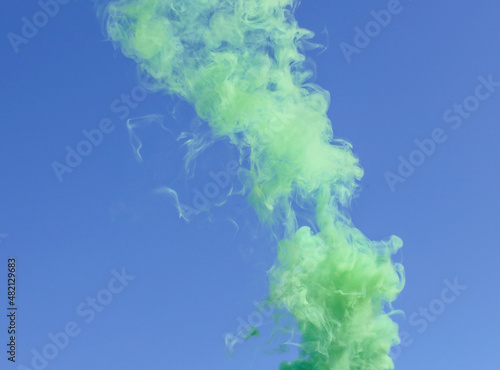 Green smoke on a blue background.