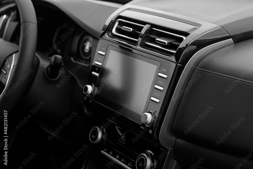 The interior of the car. Car-mounted tablet with mockup. Black and white photo The interior of the car. Car-mounted tablet with mockup. Black and white photo