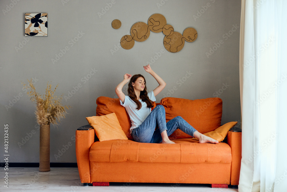 Obraz premium pretty woman relaxing at home in the room on the couch interior unaltered