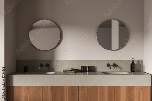Light bathroom interior with sink and mirror, accessories on deck