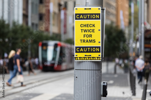 Photography A warning sign advising pedestrians to watch out for trams in George Street, Sydney,  Australia