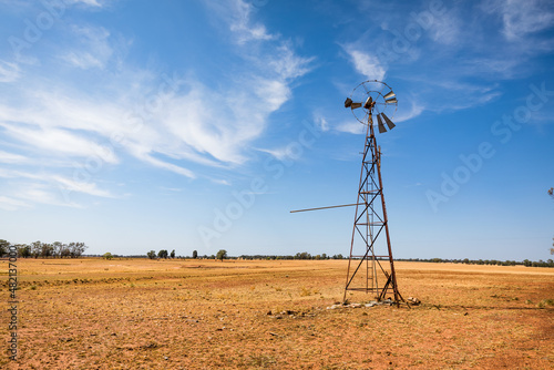 A broken down old water pump windmill on a rural farm in Outback Australia.