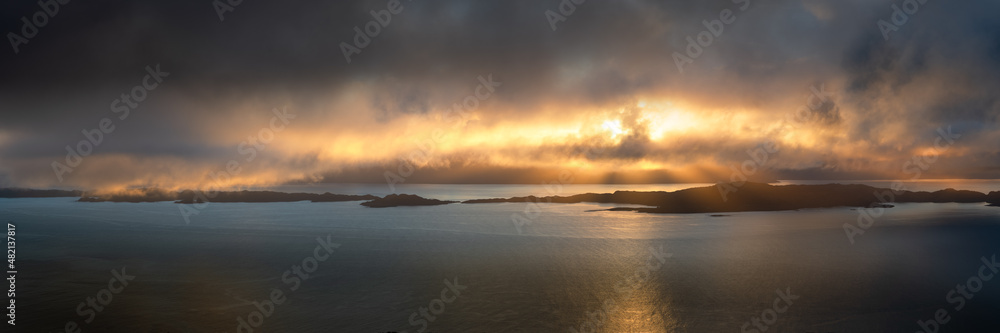 Dramatic panoramic view of Raasay; a group of small islands off the coast of The Isle of Skye in Scotland, UK. Beautiful rays of light breaking through the clouds.