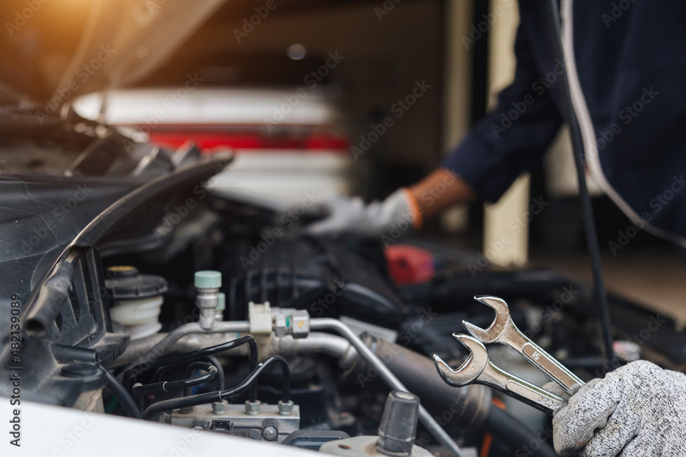 Automobile mechanic repairman hands repairing a car engine automotive workshop with a wrench, car service and maintenance,Repair service. Automobile mechanic repairman hands repairing a car engine automotive workshop with a wrench, car service and maintenance,Repair service.