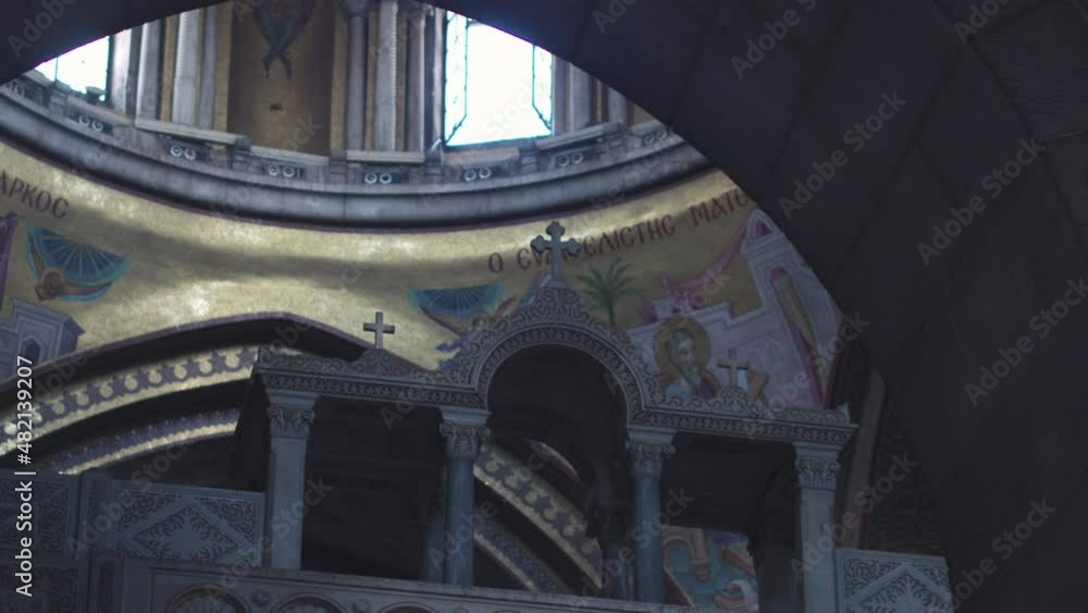 Frescoes depicting evangelists and a Greek inscription inside the dome ...