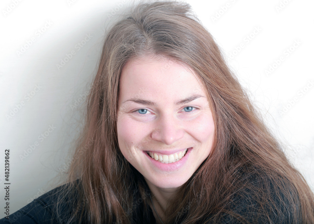 beautiful girl with long hair smiling portrait on a light background beautiful girl with long hair smiling portrait on a light background