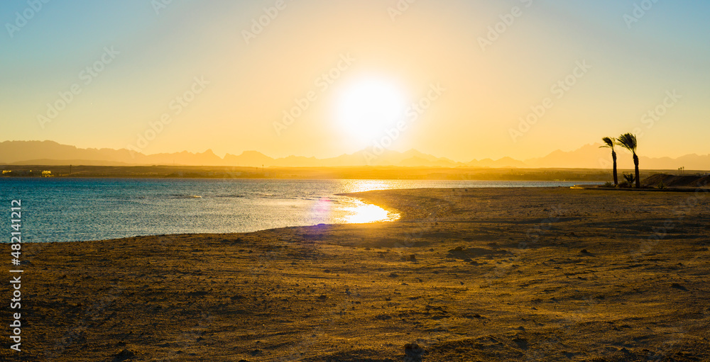 incredible fantastic sunset in sahl hasheesh panorama with sea, silhouettes of mountains and palms
