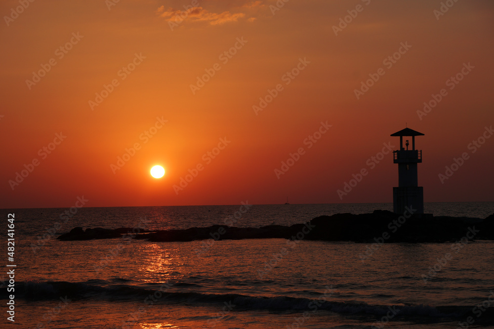 Fototapeta premium Landscape nature sunset and red twilight sky with Silhouette lighthouse on the rock at Nang Thong Beach at Khao Lak Phang Nga Thailand - Seascape chill vibe on the beach - beautiful sky 