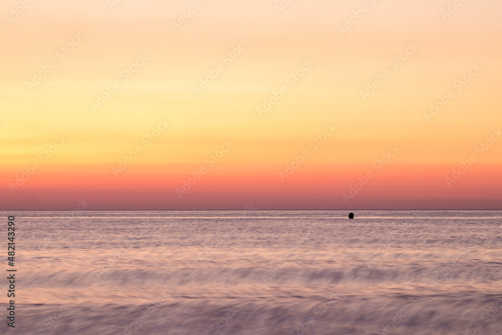 sea at sunrise with orange sky