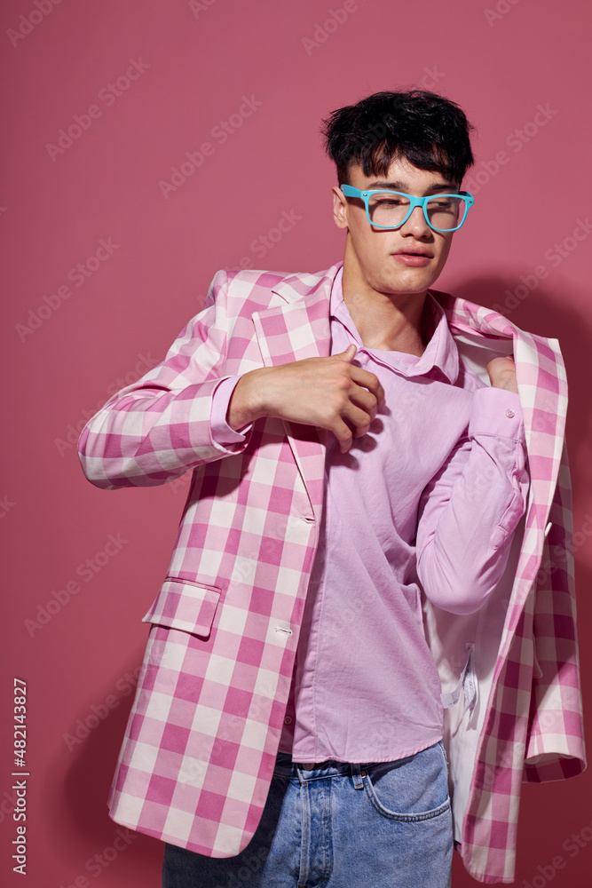 portrait of a young man fashionable glasses pink blazer posing studio pink background unaltered portrait of a young man fashionable glasses pink blazer posing studio pink background unaltered