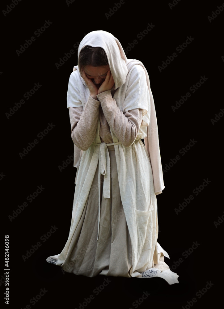 Praying woman on dark background