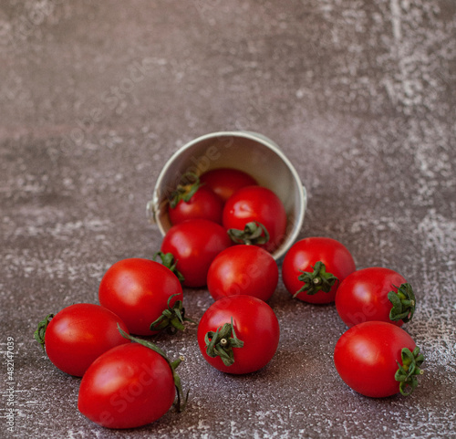 Red ripe tomatoes on dark grey cement background
