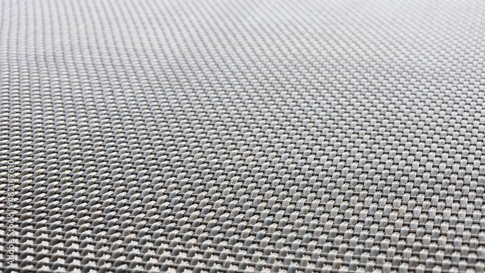 Black plastic woven background. The texture of the weave rubber material found in modern outdoor furniture. Abstract background concept. Selective focus Black plastic woven background. The texture of the weave rubber material found in modern outdoor furniture. Abstract background concept. Selective focus