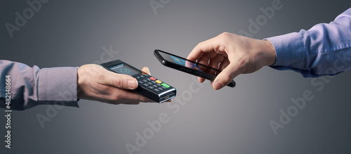 Photos Man paying with his smartphone