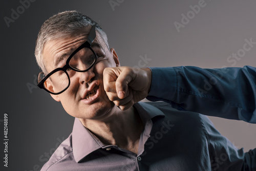 Fototapeta Man getting hit by a punch