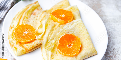 crepes thin pancake citrus Shrovetide holiday Maslenitsa sweet dessert breakfast pancakes healthy meal food snack on the table copy space food background rustic top view