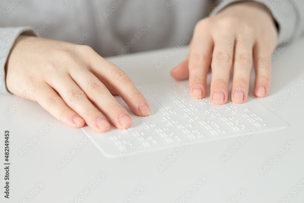 braille for the blind,hands touch the raised letters of the point braille for the blind,hands touch the raised letters of the point