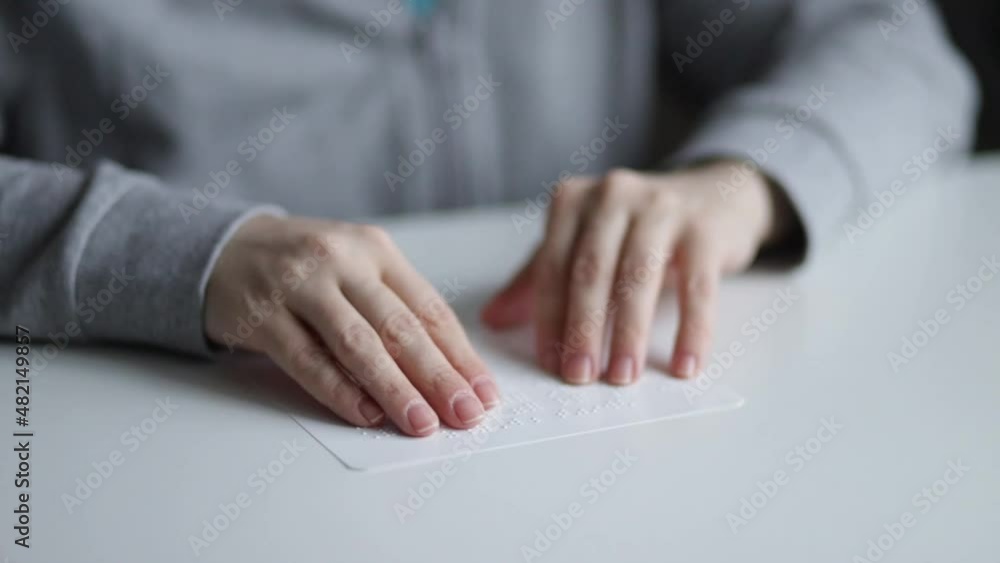 learning braille for the blind, female hands touching the dotted alphabet learning braille for the blind, female hands touching the dotted alphabet