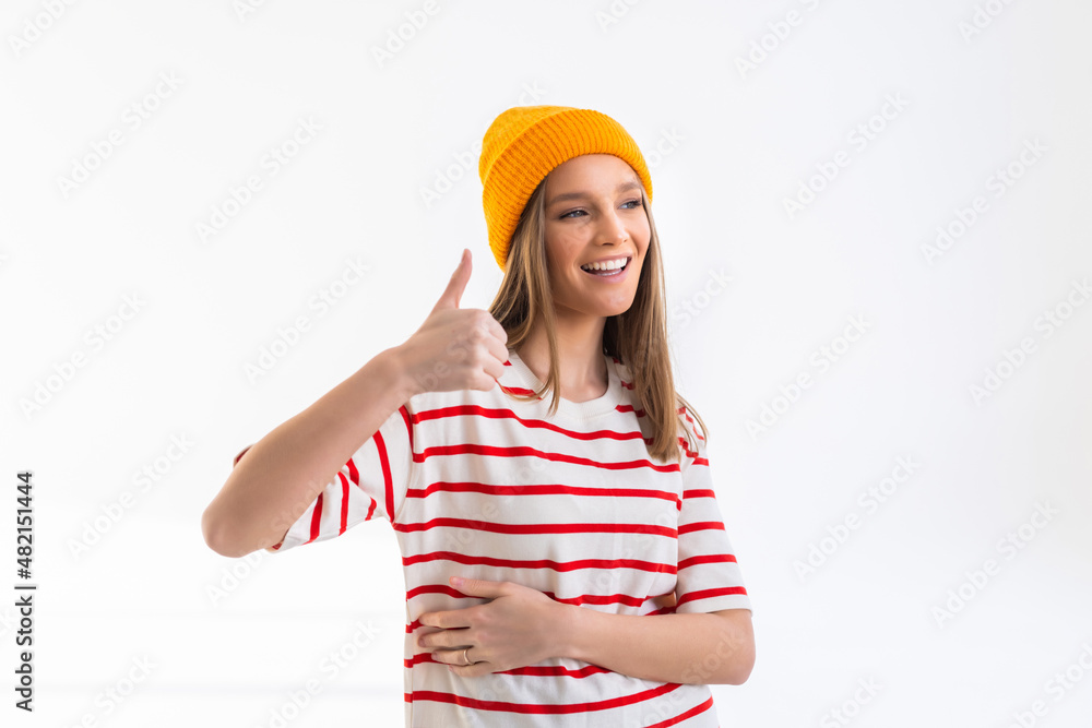 Beautiful young woman wearing hat with thumbs up, isolated on white background Beautiful young woman wearing hat with thumbs up, isolated on white background