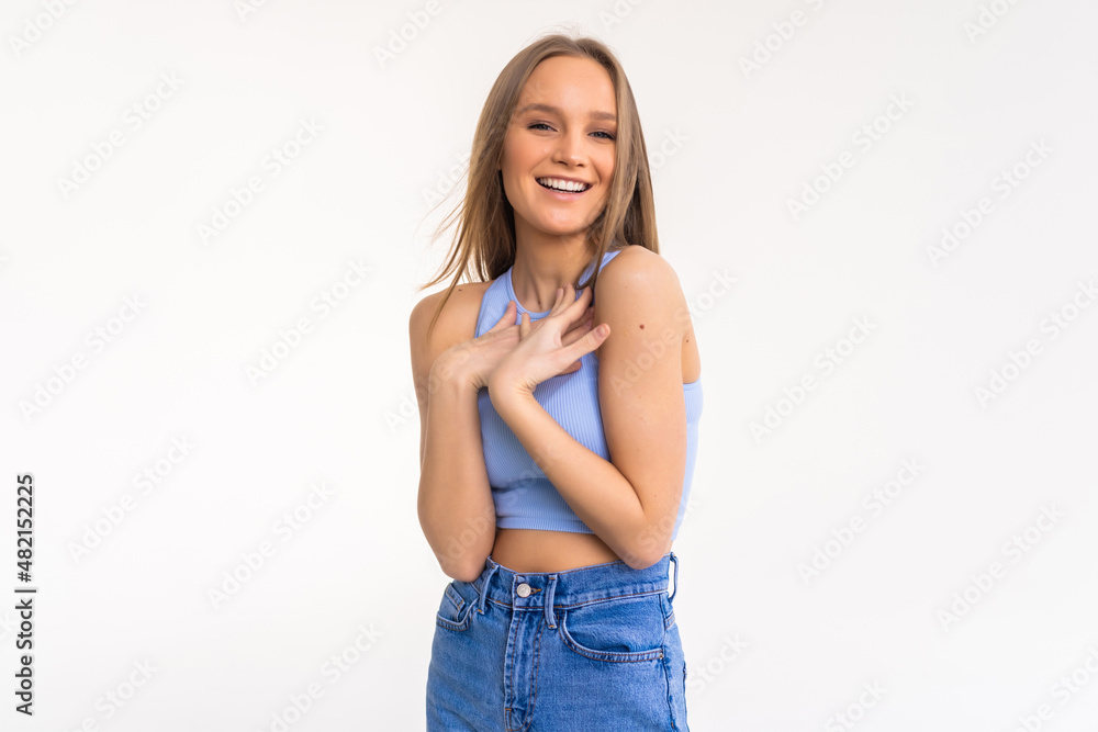 Attractive modern woman with bun, smiling broadly at camera and expressing positive emotions wjile standing over white background. Attractive modern woman with bun, smiling broadly at camera and expressing positive emotions wjile standing over white background.