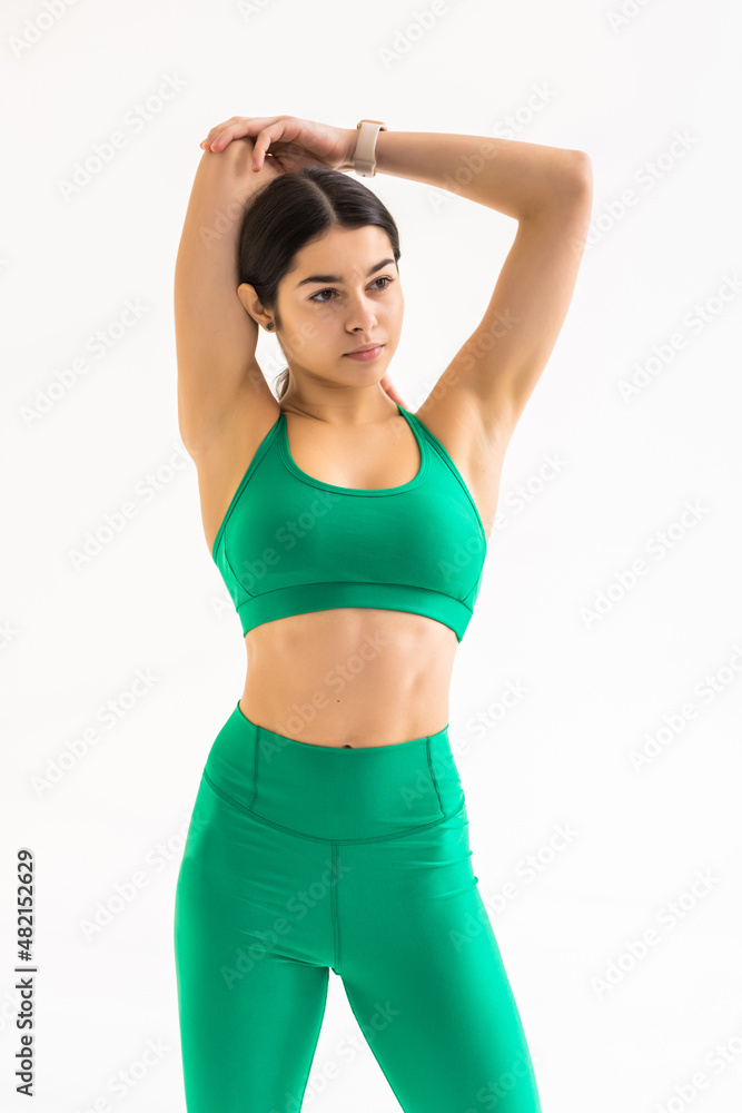 Woman stretching arms before exercise. Strong woman with perfect body on white background. Strength and motivation