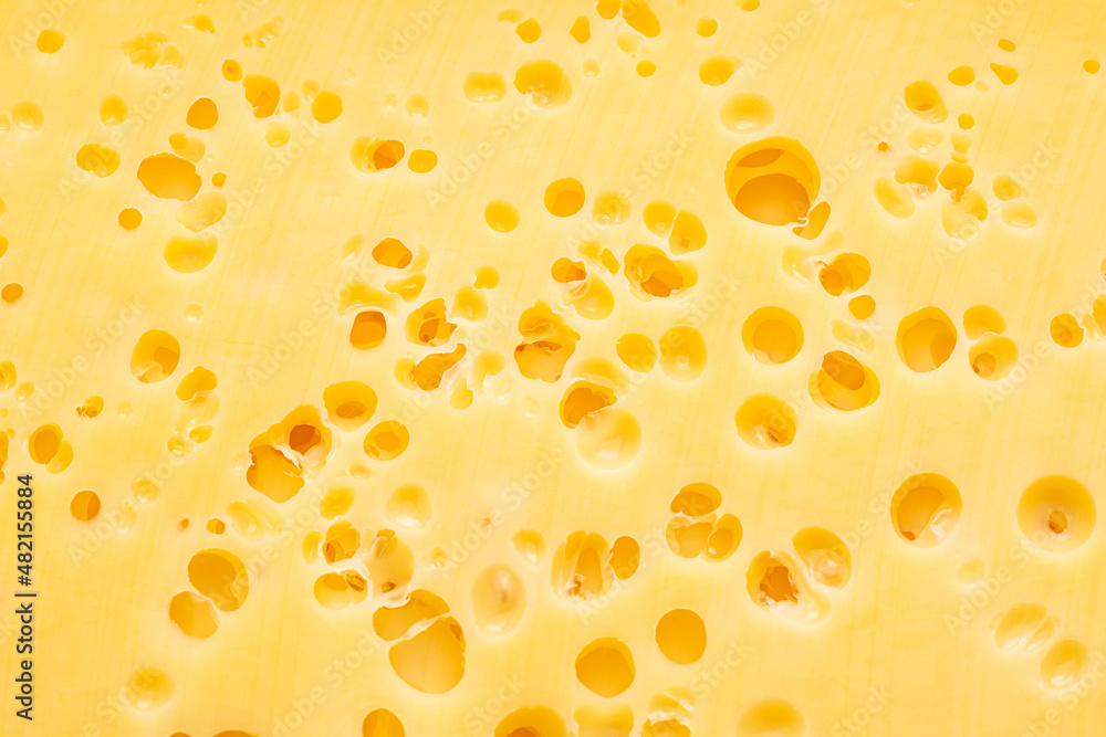 Structure of cheese with small holes close-up. Food background. Structure of cheese with small holes close-up. Food background.
