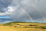 Rainbow formation over a beautiful rural landscape in Tuscany, Italy during fall