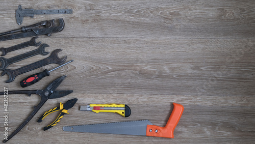 locksmith and carpentry tools on a wooden background, free space