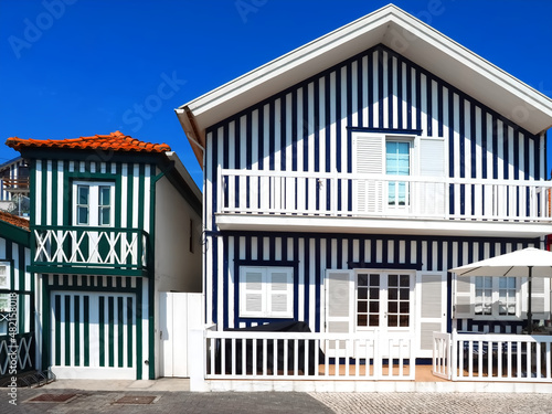 Colorful striped wooden beach houses at the promenade of Costa Nova, Aveiro, Portugal