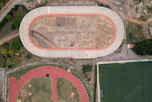 Horizontal top view of a abandoned velodrome next to a running track in Burriana, Spain photo