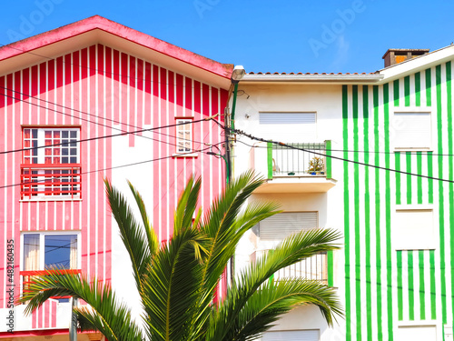 Colorful striped wooden beach houses at the promenade of Costa Nova, Aveiro, Portugal