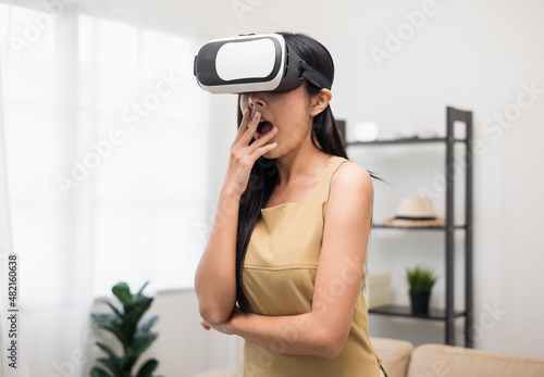 Young asian woman put on vr glasses into virtual simulated world. Future technology digital cyber universe. Person Enjoying an Experiences of Virtual World.