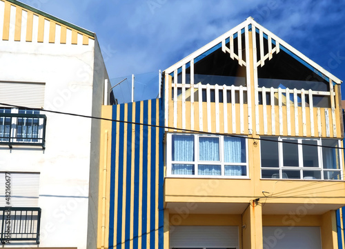 Colorful striped wooden beach houses at the promenade of Costa Nova, Aveiro, Portugal