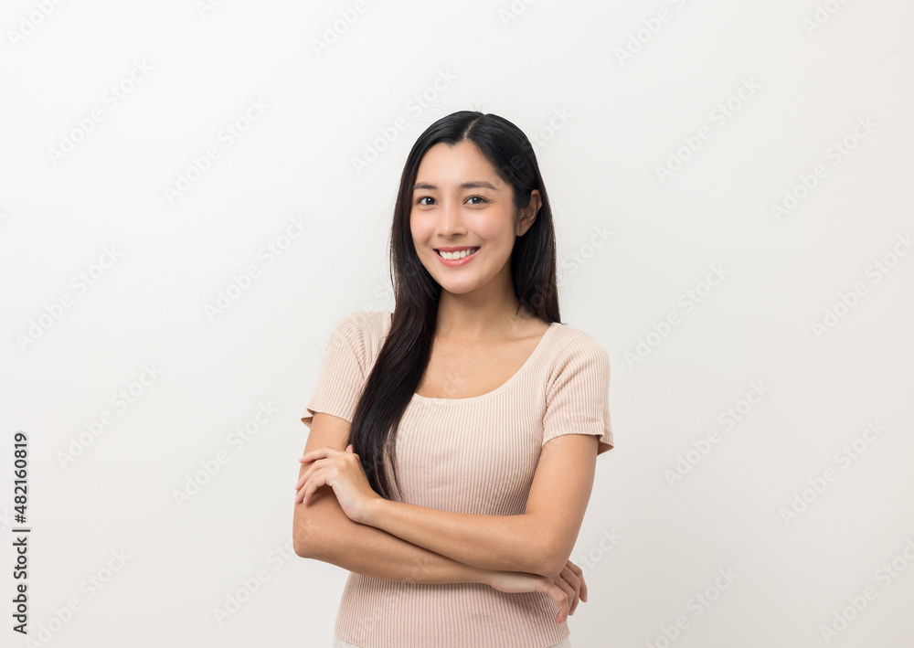 Beautiful young asian woman age around 25 smiling and happy. Charming female standing on isolated white background. Asian people pose looking camera with white backdrop.