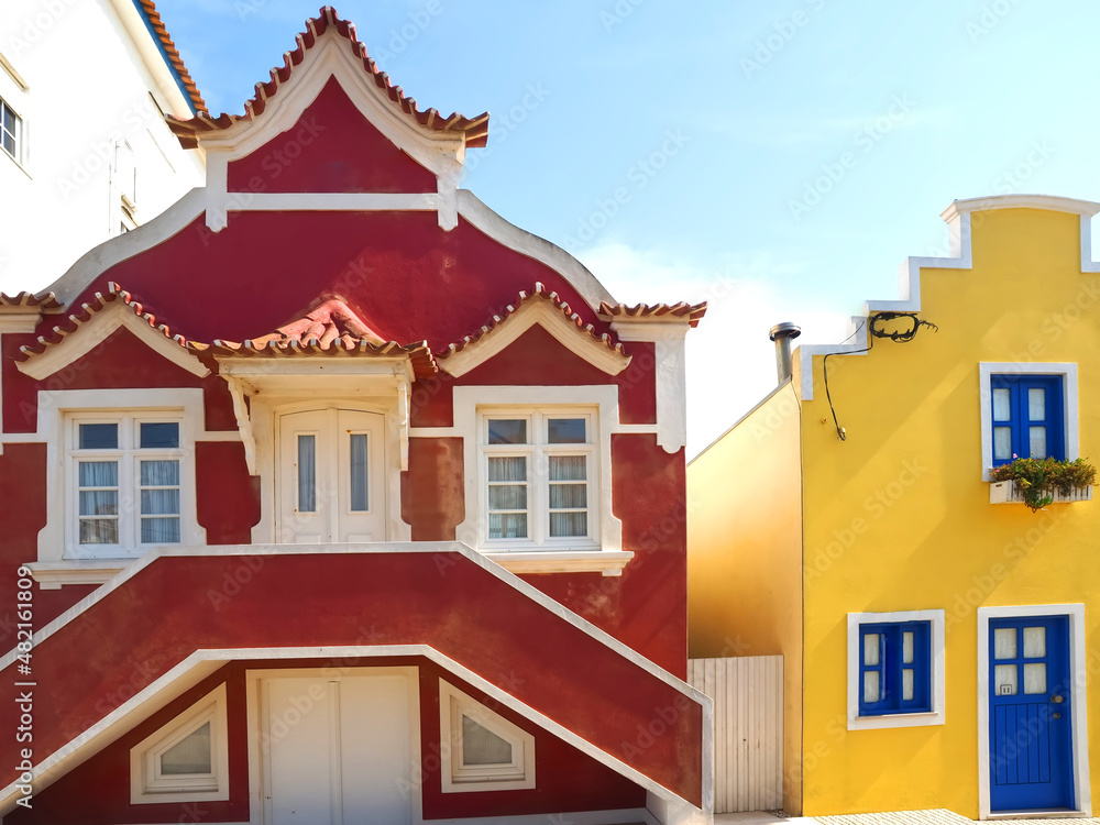 Colorful striped wooden beach houses at the promenade of Costa Nova, Aveiro, Portugal